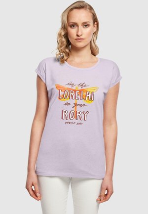 Lilac short-sleeve t-shirt featuring a graphic with a yellow-orange dragonfly and text. Soft fabric with a relaxed fit.