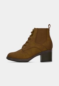 Brown lace-up ankle boot with a chunky heel, featuring a smooth leather upper and elastic side panels for easy wear.