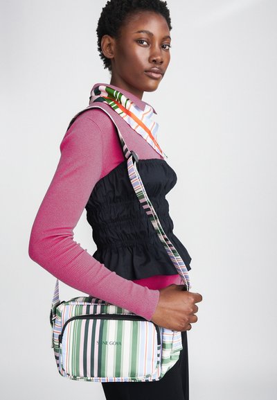 Multicolored striped handbag with a zip closure, featuring green, pink, and white stripes. Adjustable shoulder strap and logo on front.