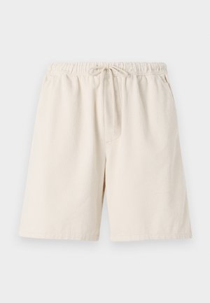 Svetlo béžové rebrované šortky s elastickým pásom a šnúrkou. Majú bočné vrecká a voľný strih. Materiál z bavlnenej zmesi.