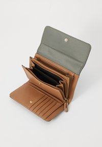 Cartera de cuero marrón con herrajes dorados, múltiples compartimentos y una sección con cremallera; cuenta con un forro de tela verde y ranuras para tarjetas de crédito.