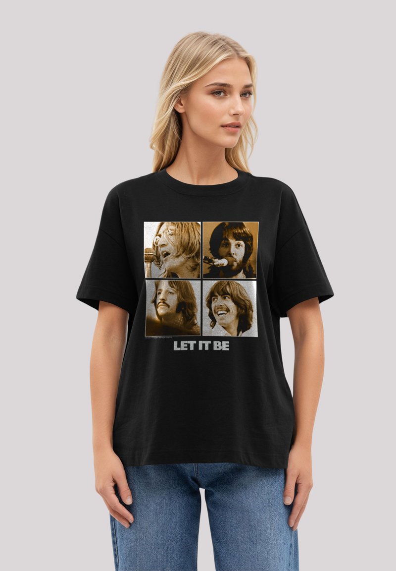 Black t-shirt featuring four sepia-tone portraits with the text "LET IT BE" in white at the bottom, round neckline, relaxed fit.