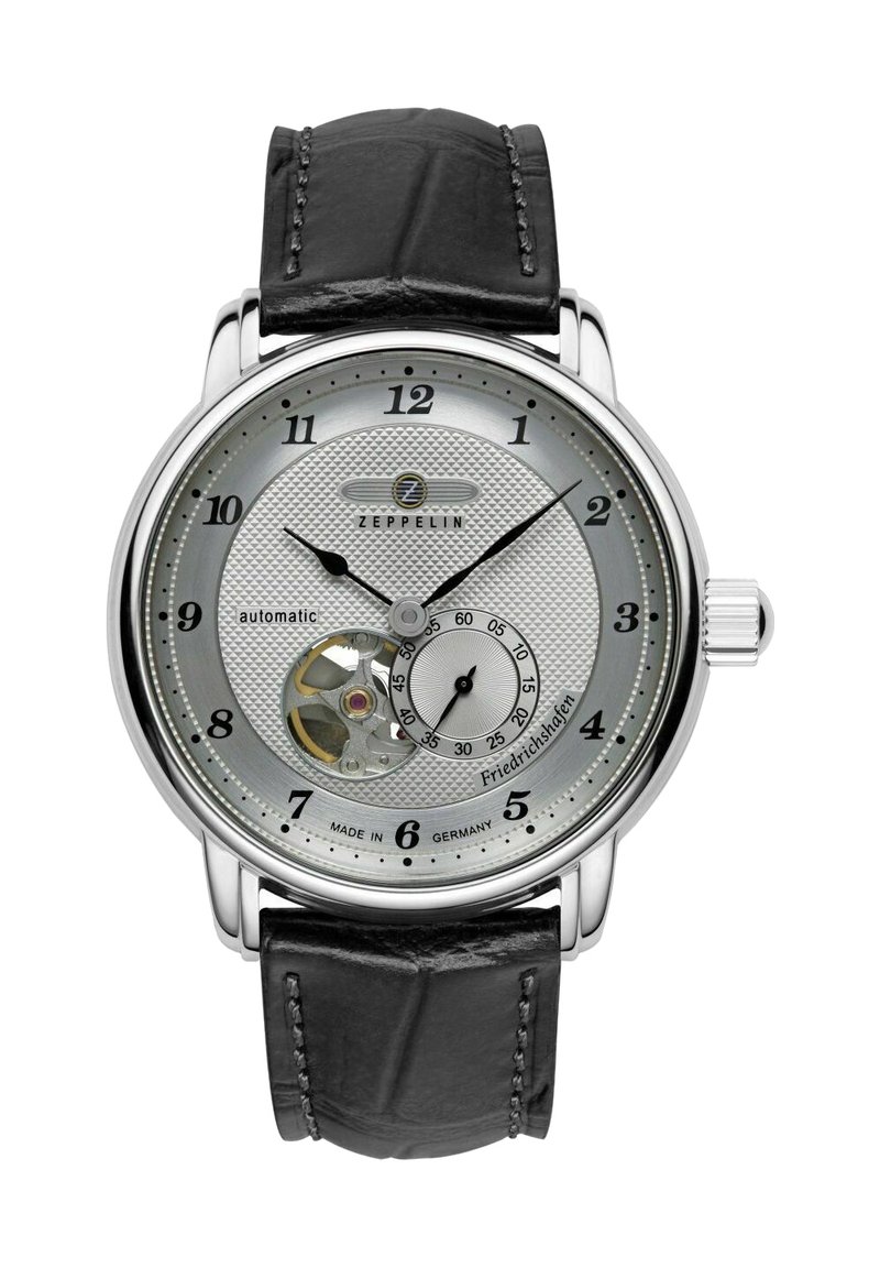 Automatic watch with a silver textured dial, black leather strap, stainless steel case, and a visible movement at 6 o'clock.
