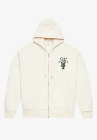 Tejfehér cipzáros kapucnis pulóver fehér csíkokkal, elülső zsebekkel és egy hímzett zöld virágvázával díszítve. Puha anyag, kényelmes kapucnival.