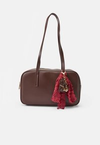 Rectangular dark brown leather handbag with two handles, adorned with a red lace scarf and gold heart-shaped charm on one handle.