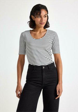 Kortærmet top med sort-hvide vandrette striber, der har en rund halsudskæring og blødt stof, parret med højtaljede sorte jeans.