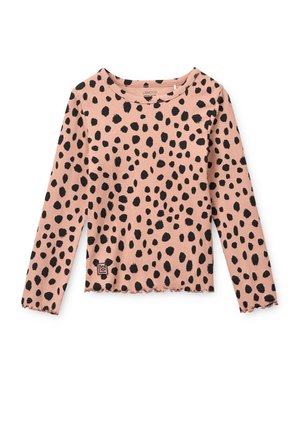 Chemise rose à manches longues avec des pois noirs irréguliers et un ourlet et des poignets festonnés, posée à plat sur un fond blanc.