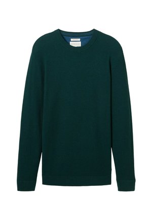 Pull en tricot vert foncé avec des manches longues, col rond, texture côtelée et ourlet droit. Étiquette visible dans la zone du col.