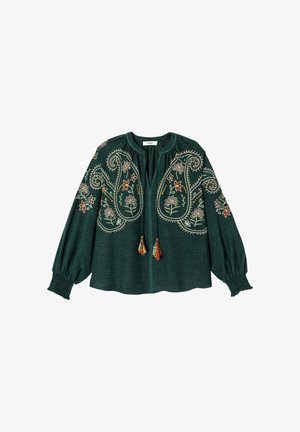 Blouse verte foncée à manches longues avec broderies florales et paisley, liens à pompons au niveau du col et poignets smockés.