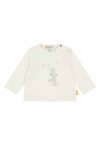 Chemise blanche à manches longues avec un col rond, présentant un dessin de lapin cartoon imprimé en couleurs pastel et une étiquette sur le côté. Matériel en coton doux.