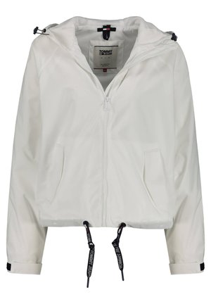 Veste blanche à capuche zippée avec cordons, poches avant et logo Tommy Jeans sur les étiquettes et les extrémités des cordons.