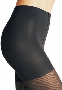 Collants opaques noirs avec une texture lisse et une finition mate, présentant un design ribbé au bas de la jambe et une large bande de taille.