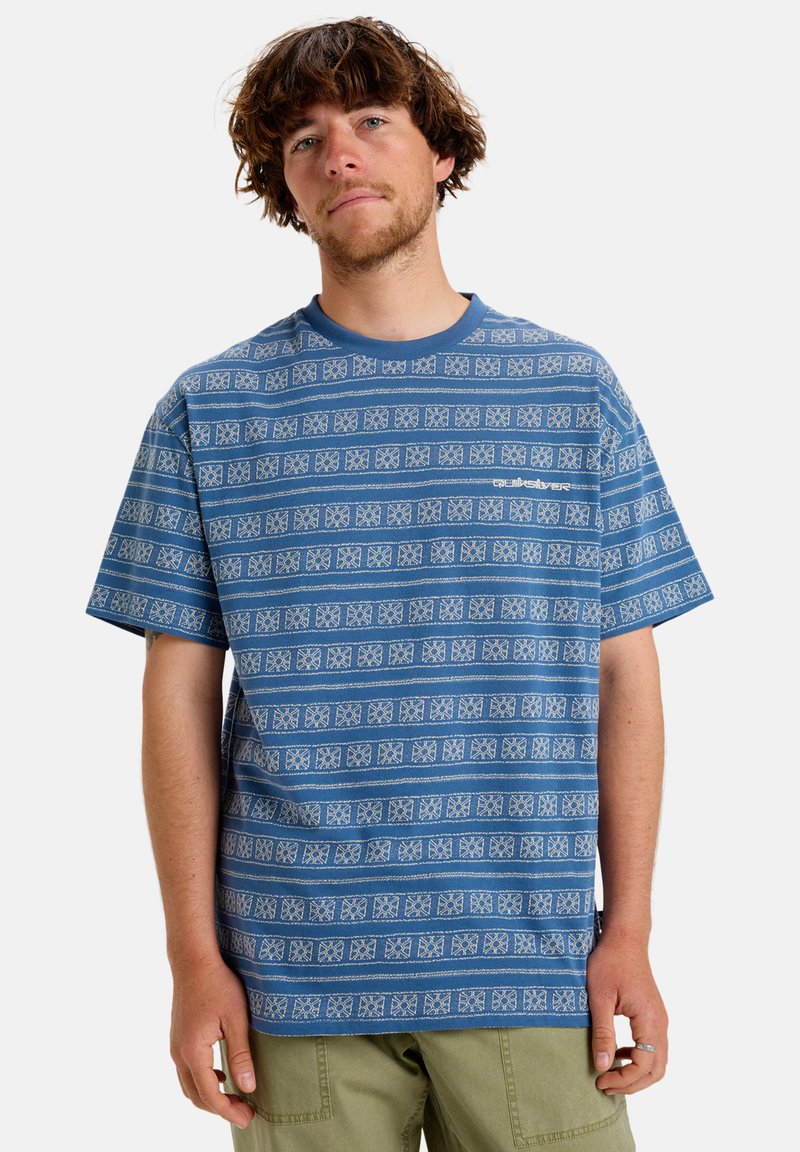 Blue short-sleeve t-shirt featuring a white geometric pattern, round neckline, relaxed fit, and soft cotton texture.