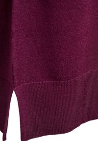 Bordo džemper glatke teksture. Sadrži rebrasti rub i bočne proreze za veću slobodu kretanja. Kratki prikaz tkanine i detalja.