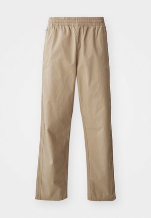 Beige, lightweight, elastic-waist pants with straight legs. Features side pockets and subtle stitching. Smooth texture, casual design.