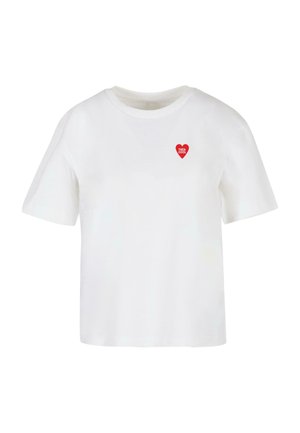 T-shirt bianco in cotone con maniche corte, collo rotondo e una grafica a forma di cuore rosso con la scritta "TRÈS COOL" stampata all'interno.