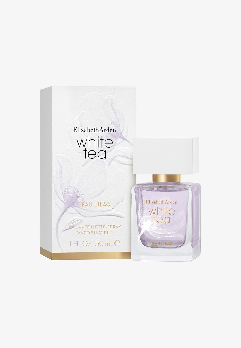 Fioletowa szklana butelka perfum z białą kwadratową zakrętką, obok jasnego pudełka z kwiatowym wzorem i złotymi akcentami. 30 ml.