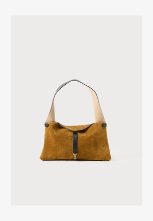 Suede handbag in mustard yellow with a black leather strap. Features a minimalistic design, smooth texture, and a central black accent.