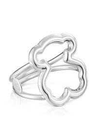 Anillo abierto de plata con un diseño de flor redondeada y ondulada de cuatro pétalos y una banda dividida delgada, marcado con "TOUS 925" en el interior.