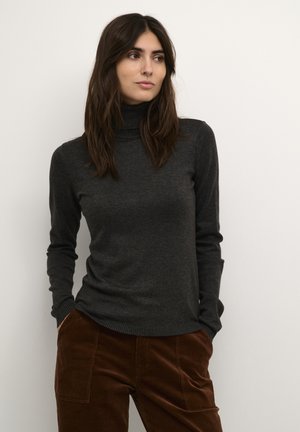 Maglione a collo alto grigio scuro realizzato in materiale morbido, con maniche lunghe e polsini a costine, abbinato a pantaloni in velluto a coste marroni.