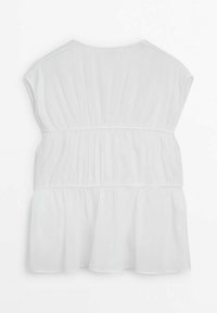 Blouse blanche sans manches avec un tissu froncé en niveaux et un encolure ronde, présentée de dos sur un fond uni.