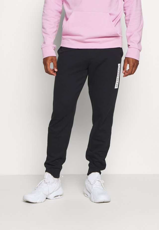 PANTS - Verryttelyhousut - black
