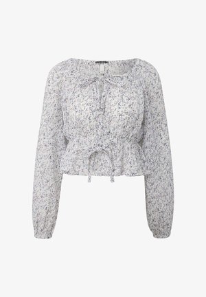 Blouse blanche à manches longues avec petit imprimé floral violet et rose, taille et poignets élastiques, et détails noués au niveau du col et de la taille.