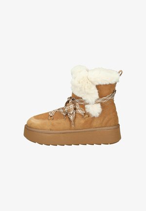 Bruine suède laarzen met een witte nepbontkraag, textuurrijke veters en een dikke, bruine rubberen zool. Kort enkellengte.