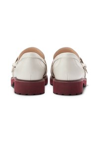 White leather shoes with a smooth finish, featuring a burgundy sole and a simple buckle detail. The design is low-cut at the back.