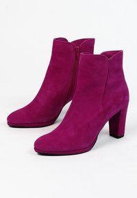 Stivaletti alla caviglia in suede fucsia con punta affusolata, chiusura con cerniera laterale e tacco a blocco. Texture liscia e design minimalista.