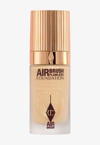 Charlotte Tilbury Airbrush Flawless Foundation bottle with gold ribbed cap, beige liquid foundation, and winged logo on frosted glass.