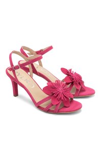 Różowe zamszowe sandały na wysokim obcasie z kwiatowymi akcentami; projekt z paskiem wokół kostki; otwarty czubek; gładka tekstura; obcasy o wysokości około 4 cali.