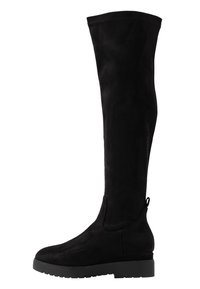 Bottes noires au-dessus du genou en suède, dotées d'une semelle plate, d'une texture lisse et d'une boucle en haut pour un ajustement facile.
