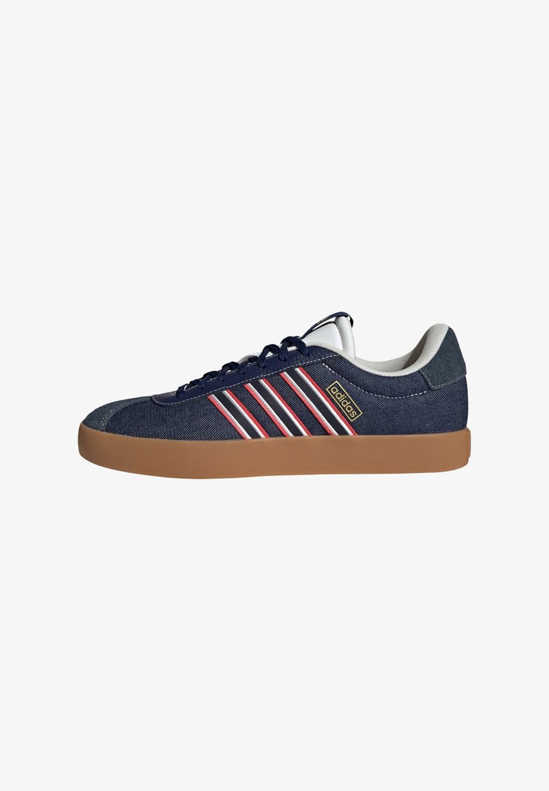 Navy blue athletic shoe featuring a denim upper, three white and red stripes, and a gum rubber sole. Soft white lining and laces.