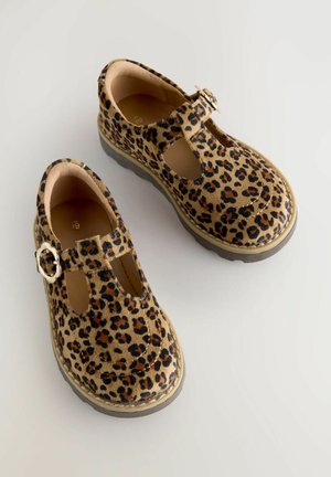 Brown and black leopard print shoes with a T-strap design, secured by a round metallic buckle, featuring a thick rubber sole.
