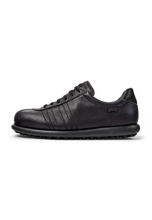 Black leather sneakers with a textured finish, featuring laces and a rubber sole, displayed from the side against a white background.