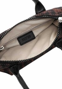 Small handbag with a black and brown patterned exterior, synthetic material, zip closure, and beige fabric lining with a label inside.
