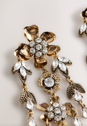 Gold-tone floral earrings featuring clear rhinestones, leaf accents, and intricate metallic detailing. Decorative design with multiple blooms.