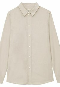 Chemise à manches longues beige clair avec un col classique, fermeture à boutons sur le devant et texture de tissu lisse. Aucun motif ni accent.