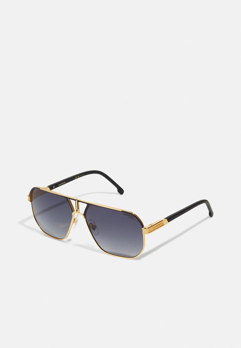Ochelari de soare cu ramă din metal auriu, cu lentile gri în degrade, formă pătrată, brațe negre și logo-ul vizibil al mărcii pe brațe.