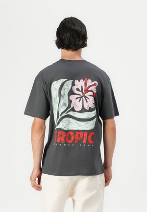 Grey cotton t-shirt featuring a large floral design in pink and green, with red "TROPIC" text and “SUMMER CLUB” below. Short sleeves and crew neckline.