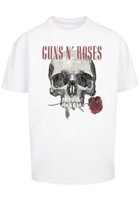 White short-sleeve t-shirt featuring a graphic design of a skull with a rose and the text "GUNS N' ROSES" in red above.
