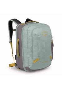 Zaino di colore verde chiaro e grigio realizzato in un tessuto resistente con un motivo a griglia, con dettagli gialli, numerose tasche e spallacci imbottiti.