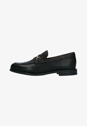 Black leather loafer with textured finish, soft round toe, low stacked heel, and decorative metal accent on the vamp. Smooth interior lining.
