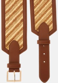 Braided natural straw strap with brown leather ends; gold-tone buckle; features geometric pattern and textured surface.