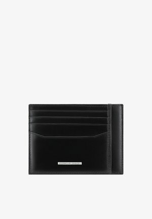 Black leather cardholder with four card slots and a silver Porsche Design logo plate on the front, shown against a white background.