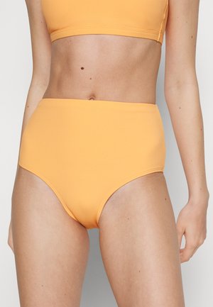 Høyt midje bikini-bunn i ribbet tekstur, lys oransje farge, med sømløst design og rene linjer for en tettsittende silhuett.