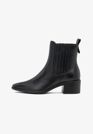 Stivale alla caviglia in pelle nera con pannelli laterali elasticizzati, punta affusolata e tacco basso a blocco. Texture liscia e design elegante e minimalista.