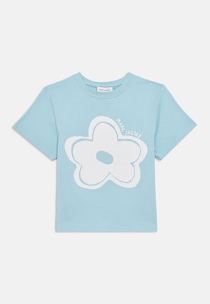 Light blue cotton t-shirt featuring a large white flower graphic with a circular center and the text "MARC JACOBS" in a playful font.