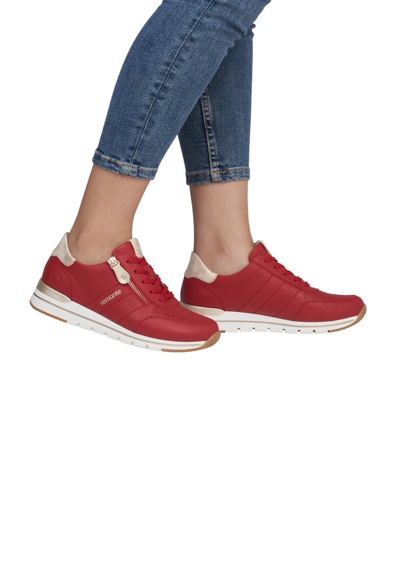 Red leather sneakers with beige accents, perforated design, and white sole featuring a gold stripe. Includes a zipper detail on the side.